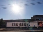 A banner with a growing collection of well-wishes from supporters reads "bring her home" and shows a photo of Nancy Guthrie, the 84-year-old mother of U.S. journalist and television host Savannah Guthrie, who disappeared from her home nearly two weeks ago, outside of the KVOA newsroom in Tucson, Arizona, U.S., February 14, 2026. REUTERS/Rebecca Noble