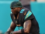 Miami Dolphins' Tyreek Hill looks toward the field son the sideline before an NFL football game against the New York Jets. Miami Dolphins' Tyreek Hill looks toward the field son the sideline before an NFL football game against the New York Jets.
