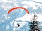 Tourists enjoying  paragliding  at Solang Valley in Manali on Monday. (Aqil Khan /HT)