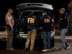 The FBI and Pima County Sheriff’s Department deputies process evidence from a late-model, gray Range Rover as they investigate the disappearance of Nancy Guthrie, the 84-year-old mother of U.S. journalist and television host Savannah Guthrie, at a Culver’s in Tucson, Arizona, U.S. February 14, 2026.  REUTERS/Rebecca Noble     TPX IMAGES OF THE DAY