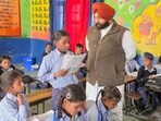 Education minister Harjot Singh Bains checking the learning progress of students at Government Primary School, Indira Colony, Machhiwara, on Tuesday. (HT Photo) Education minister Harjot Singh Bains checking the learning progress of students at Government Primary School, Indira Colony, Machhiwara, on Tuesday. (HT Photo)