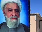 A poster of Lebanese Shiite movement Hezbollah's leader Naim Qassem (L) is displayed near another of the group's late leader Hassan Nasrallah outside shelters at the Imam Ali Housing Compound, where displaced Lebanese and Syrian refugee Shiite Muslims take refuge by the city of Hermel in Lebanon's northeastern Bekaa valley on February 4, 2026. (Photo by Joseph EID / AFP) A poster of Lebanese Shiite movement Hezbollah's leader Naim Qassem (L) is displayed near another of the group's late leader Hassan Nasrallah outside shelters at the Imam Ali Housing Compound, where displaced Lebanese and Syrian refugee Shiite Muslims take refuge by the city of Hermel in Lebanon's northeastern Bekaa valley on February 4, 2026. (Photo by Joseph EID / AFP)