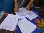 Election Commission officials assist voters at a help desk camp for the Special Intensive Revision (SIR) of Electoral Rolls, in Sonagachi, Kolkata.