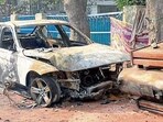 The car that caught fire after hitting an electricity pole in Upkar Nagar on Tuesday. (Manish/HT) The car that caught fire after hitting an electricity pole in Upkar Nagar on Tuesday. (Manish/HT)