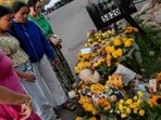 TUSCON, ARIZONA - FEBRUARY 15: People pay their respects at a makeshift memorial outside of Nancy Guthrie's residence on February 15, 2026 in Tuscon, Arizona. (Photo by Brandon Bell / GETTY IMAGES NORTH AMERICA / Getty Images via AFP)