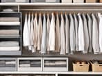 A neatly arranged wardrobe featuring stackable boxes, hanging shelves and drawer dividers creates twice the space with ease.(Ai generated)