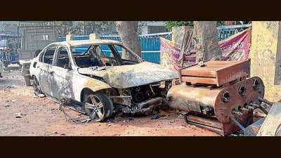 The car that caught fire after hitting an electricity pole in Upkar Nagar on Tuesday. (Manish/HT)