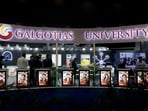 Visitors stand at the Galgotias University kiosk at Bharat Mandapam, one of the venues for AI Impact Summit, in New Delhi, India