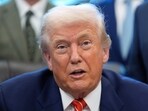 President Donald Trump speaks to reporters in the Oval Office of the White House.