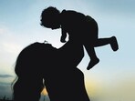 A woman plays with her child. (AP File)