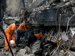 Rescue workers search for bodies among the rubble after a massive fire broke out at a shopping mall in Karachi on January 21, 2026. 