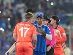 Suryakumar Yadav shakes hands with Logan van Beek of Netherlands.