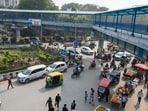 The intersection witnesses thousands of people daily, most of whom choose to cross the road by dodging cars, buses, and other vehicles rather than using the skywalk. (Parveen Kumar/HT)
