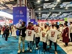 Indian Youth Congress (IYC) workers stage a protest, walking around holding t-shirts with slogans against the government and the India-US trade deal printed on them, at the AI Impact Summit in New Delhi.