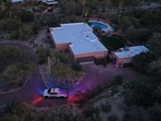 A view of Nancy Guthrie's house with a Pima County Sheriff's Department vehicle visible. 