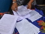 Election Commission officials assist voters at a help desk camp for the Special Intensive Revision (SIR) of Electoral Rolls, in Sonagachi, Kolkata. Election Commission officials assist voters at a help desk camp for the Special Intensive Revision (SIR) of Electoral Rolls, in Sonagachi, Kolkata.