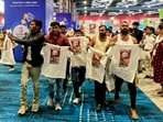Indian Youth Congress (IYC) workers stage a 'shirtless protest', walking around holding T-shirts with slogans against the government at the AI Impact Summit in Delhi on Friday