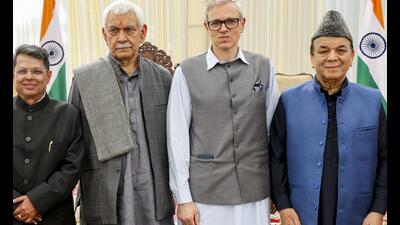 (From right) Speaker Abdul Rahim Rather, J&K CM Omar Abdullah and LG Manoj Sinha with former IAS officer Shantmanu, during his oath-taking ceremony as the Jammu and Kashmir state election commissioner at Lok Bhawan, in Jammu, on Saturday. (PTI) (From right) Speaker Abdul Rahim Rather, J&K CM Omar Abdullah and LG Manoj Sinha with former IAS officer Shantmanu, during his oath-taking ceremony as the Jammu and Kashmir state election commissioner at Lok Bhawan, in Jammu, on Saturday. (PTI)