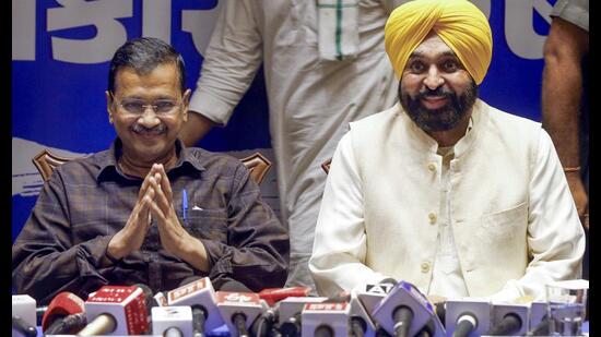 Aam Aadmi Party (AAP) national convener Arvind Kejriwal and Punjab chief minister Bhagwant Mann address a press conference on the recent Gujarat state Budget on the first day of their two-day visit to Gujarat, in Ahmedabad on Saturday. (ANI)
