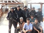 Coast guard personnel with the apprehended smugglers off the coast of Gujarat. (X)