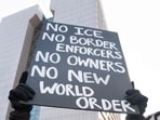 An anti-ICE banner being held up by a protester in Minnesota, USA
