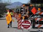 A road crew sets up signs and barricades in front of Nancy Guthrie's residence to turn the two-lane road into a one-lane road on February 21, 2026, in Tucson, Arizona. A road crew sets up signs and barricades in front of Nancy Guthrie's residence to turn the two-lane road into a one-lane road on February 21, 2026, in Tucson, Arizona.