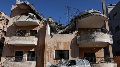 A destroyed vehicle lies next to a damaged building, in the aftermath of an Israeli strike on Friday, in Riyak, Bekaa valley, Lebanon, February 21, 2026. REUTERS/Mohamed Azakir (REUTERS)