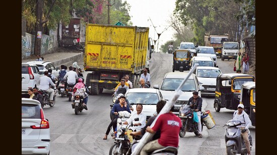 A local shopkeeper said wet garbage spilling from dumpers often makes the road slippery. (MAHENDRA KOLHE/ HT)