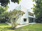 The house is organised with wide verandahs wrapping portions of it, columned and well-spaced to let light pour in.