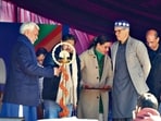 J&k LG Manoj Sinha along with CM Omar Abdullah lighting lamps during the inauguration of the Khelo India Winter Games in Gulmarg, on Monday. (Waseem Andrabi/HT)