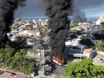 Smoke billows from burning vehicles amid a wave of violence, with torched vehicles and gunmen blocking highways in more than half a dozen states, following a military operation in which Mexican drug lord Nemesio Oseguera, known as "El Mencho," was killed,