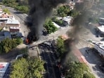 Smoke billows from burning vehicles amid a wave of violence, with torched vehicles and gunmen blocking highways in more than half a dozen states, following a military operation in which a government source said Mexican drug lord Nemesio Oseguera, known as "El Mencho," was killed, in Puerto Vallarta, Jalisco, Mexico.