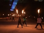 Skiers hold flaming torches on Sunday night on the eve of the sixth edition of the Khelo India Winter Games in Gulmarg on Sunday. J&K lieutenant governor Manoj Sinha inaugurated a laser and torch show on the occasion (. Waseem Andrabi/HT)