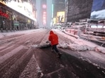 A person clears a snow covered street during a winter storm in the Manhattan borough of New York City on February 23