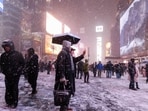 Pedestrians in the snow at Times Square during a winter storm in New York, US, on Sunday, Feb. 22, 2026.