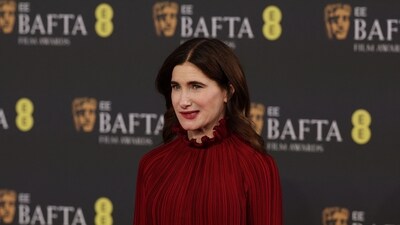 Kathryn Hahn posed with style in a red ruffled gown. In the sea of white and black ensembles at the event, this look stood out because of the vibrant colour. (AFP) Kathryn Hahn posed with style in a red ruffled gown. In the sea of white and black ensembles at the event, this look stood out because of the vibrant colour. (AFP)