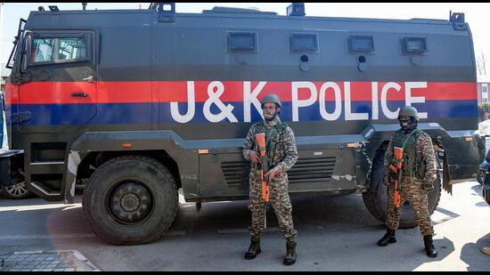 Security personnel stand guard outside the Congress headquarters during the Youth Congress's protest in Srinagar on Monday. (ANI)