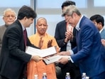 CM Yogi Adityanath, centre, witnesses the signing of an MoU between SATS Ltd and the Uttar Pradesh government for development of a cargo complex and air catering facility at Noida International Airport, in Singapore. (Sourced)