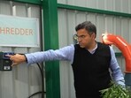 Delhi PWD minister Pravesh Verma switches on the machinery at the plant on Tuesday. (HT Photo)