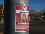 A sign placed by Madres Buscadoras De Sonora (Searching Mothers of Sonora), reads 'Nancy Guthrie Desparecida' (Disappeared) after they placed it on a pole about a mile from Nancy Guthrie's residence in Tucson, Arizona.