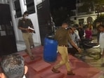 Police recovering the blue drum from the Ashiana home late on Monday night. (Sourced)