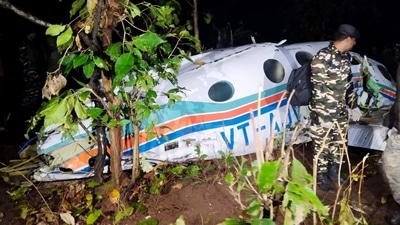 A security officer inspects the plane debris at the crash site after an air ambulance of Redbird Airways Pvt Ltd Beechcraft C90 aircraft VT-AJV crashed shortly after takeoff from Jharkhand's Ranchi, killing everyone onboard. (PTI) A security officer inspects the plane debris at the crash site after an air ambulance of Redbird Airways Pvt Ltd Beechcraft C90 aircraft VT-AJV crashed shortly after takeoff from Jharkhand's Ranchi, killing everyone onboard. (PTI)