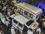 People gather around ambulances outside a hospital in Meerut. 