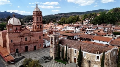 The Church of Our Lady of Guadalupe and the main square of Tapalpa, Jalisco state, Mexico, where police sealed off the resort area after the clash. Locals reported that Oseguera’s two-storey stone villa, adorned with large religious imagery, was left riddled with bullet casings, alongside an abandoned Jeep. Images circulating in Mexican media showed disordered rooms, open drawers, unmade beds, and a table displaying religious icons, candles, handwritten prayers, and medication linked to the cartel leader’s long-standing kidney illness. (Photo by Ulises RUIZ / AFP) (AFP)