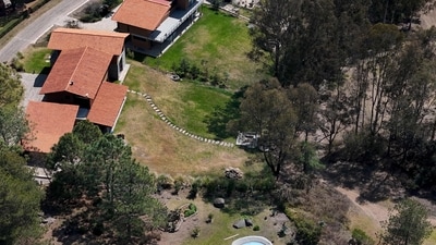 Gunfire and the sound of helicopters shattered the calm of the holiday resort in the western Mexican town of Tapalpa early on Sunday, sending shockwaves through tourists who had been enjoying a quiet getaway. Visitors staying at the luxury cabins described scenes of fear and confusion as heavy gunfire broke out at dawn. One tourist said the sound of automatic weapons firing from both the ground and the air grew steadily louder, creating an atmosphere of intense dread. According to his account, the exchange of fire continued for nearly two hours. (Photo by Ulises RUIZ / AFP) (AFP)