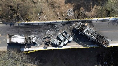 Burned vehicles over the "La Desembocada" bridge in Puerto Vallarta, Jalisco State, following the narco chaos on after the death of the druglord “El Mencho,” The popular tourist destination saw dozens of incinerated vehicles line the streets and vandalized stores remain empty. (Photo by Alfredo ESTRELLA / AFP) (AFP)
