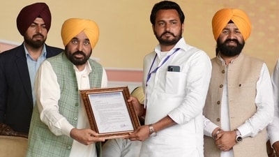 Mann hands over a framed citation to a local representative at the Sardulgarh event in Mansa on February 24, 2026. Mann hands over a framed citation to a local representative at the Sardulgarh event in Mansa on February 24, 2026.