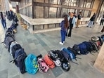 FIRST COME, FIRST SERVE: At the Sector 34 library, when the waiting line gets long, students often leave their bags behind to reserve their spot. (Ravi Kumar/HT)