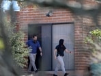 TUCSON, ARIZONA - FEBRUARY 25: Law enforcement officials walk around Nancy Guthrie's residence on February 25, 2026 in Tucson, Arizona. (Photo by JOE RAEDLE / GETTY IMAGES NORTH AMERICA / Getty Images via AFP)