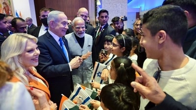 Prime Minister Narendra Modi with Israeli Prime Minister Benjamin Netanyahu and his wife Sara Netanyahu interacts with children during Festive Knesset Reception, in Jerusalem on Wednesday. (@IsraeliPM/X) Prime Minister Narendra Modi with Israeli Prime Minister Benjamin Netanyahu and his wife Sara Netanyahu interacts with children during Festive Knesset Reception, in Jerusalem on Wednesday. (@IsraeliPM/X)